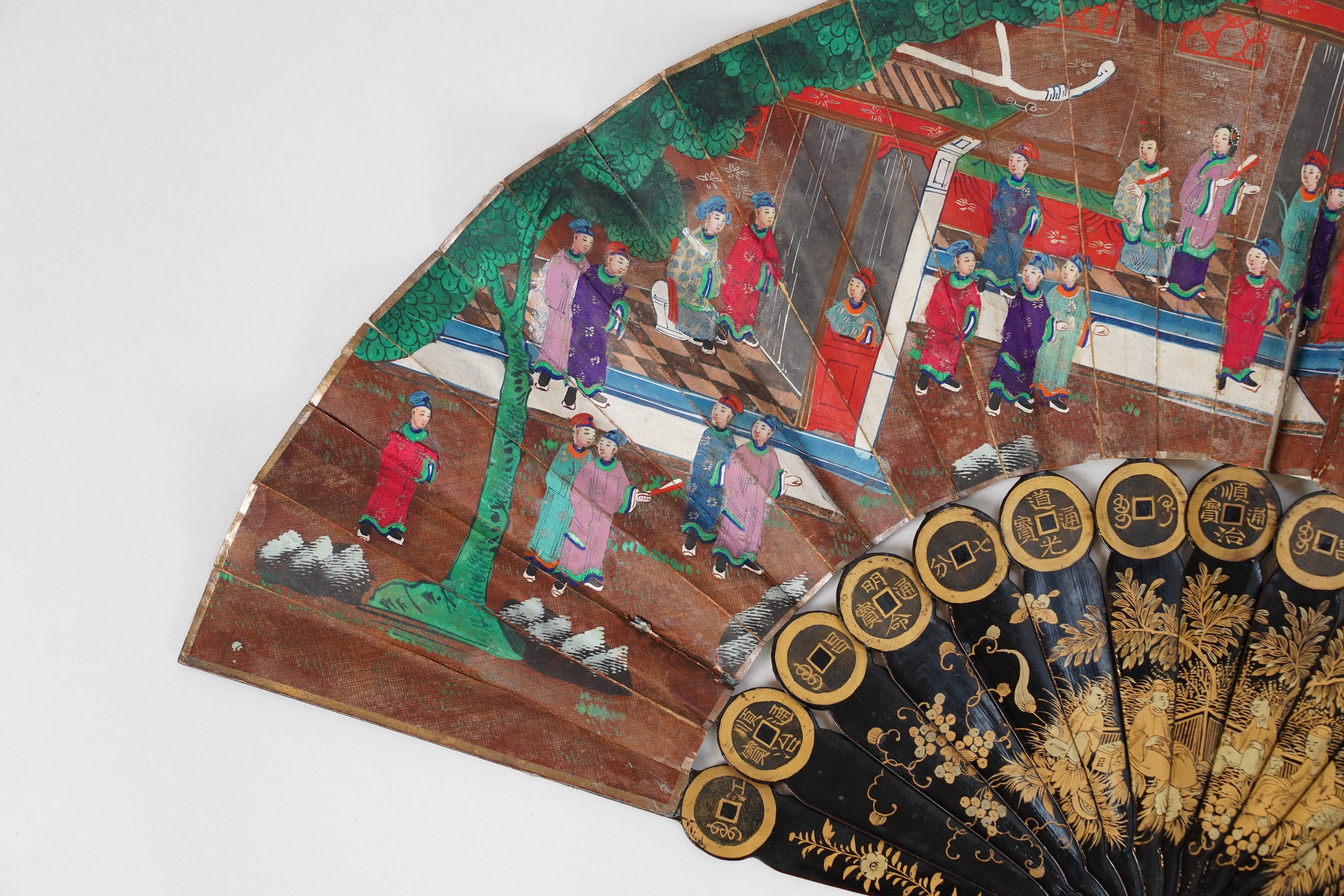 Three Chinese gilt-decorated black lacquer and painted leaf fans, 19th century